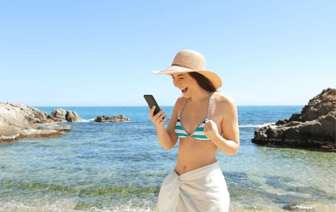 A girl on her phone at the beach
