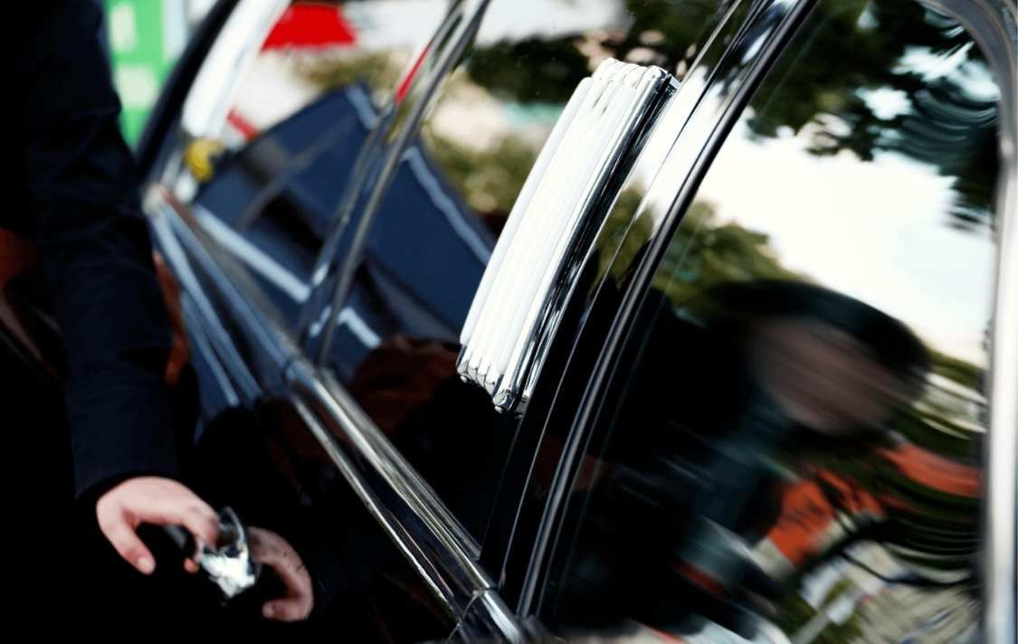 Chauffeur opening a car door
