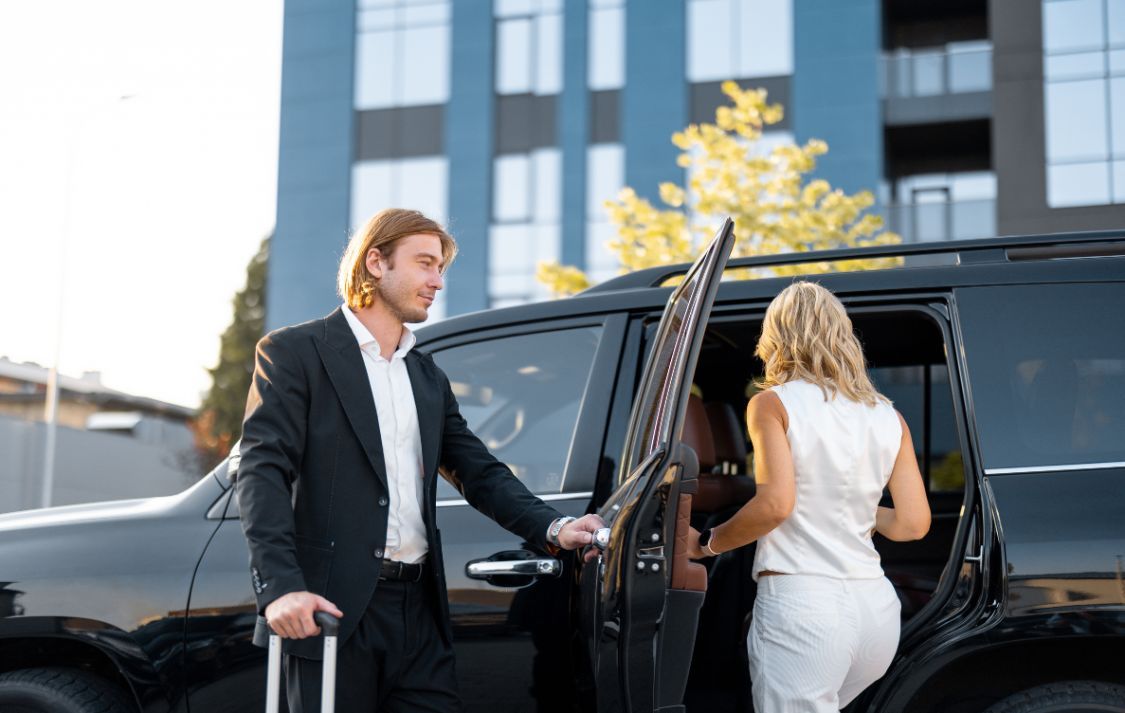Chauffeur opening a car door for a passenger