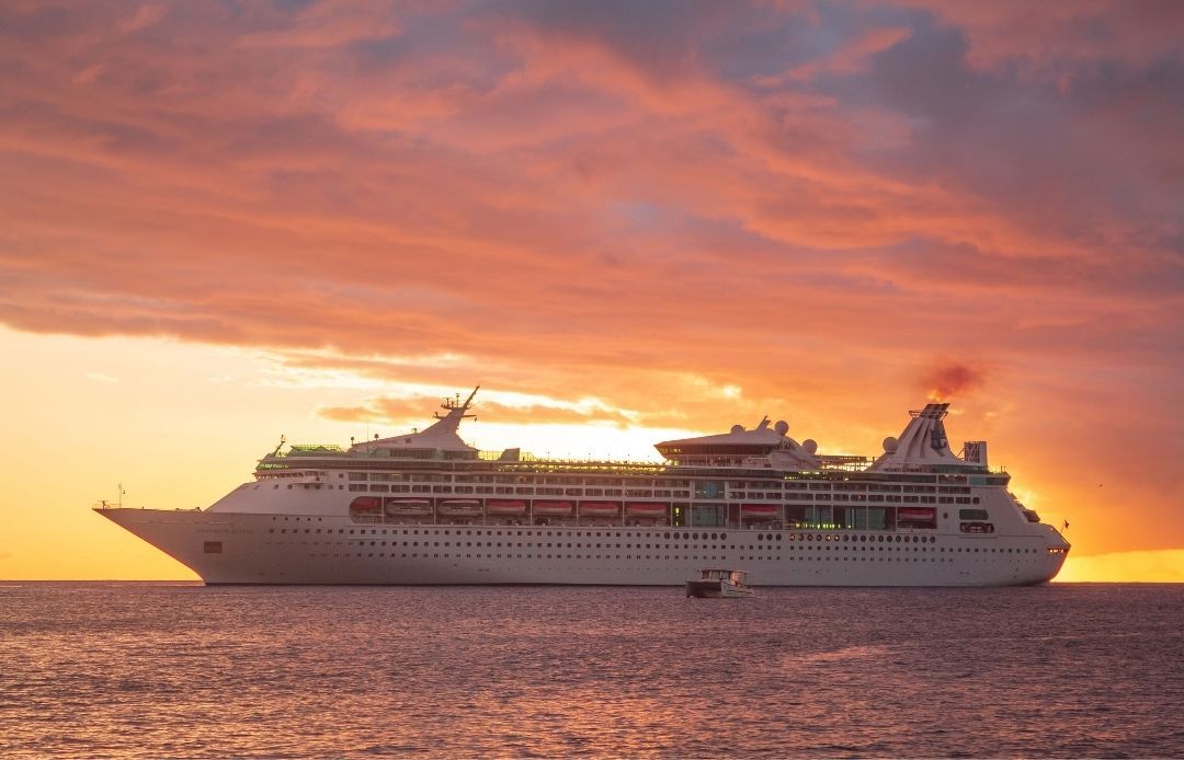 Cruise Line Transportation Ship Out to Sea with Sunset