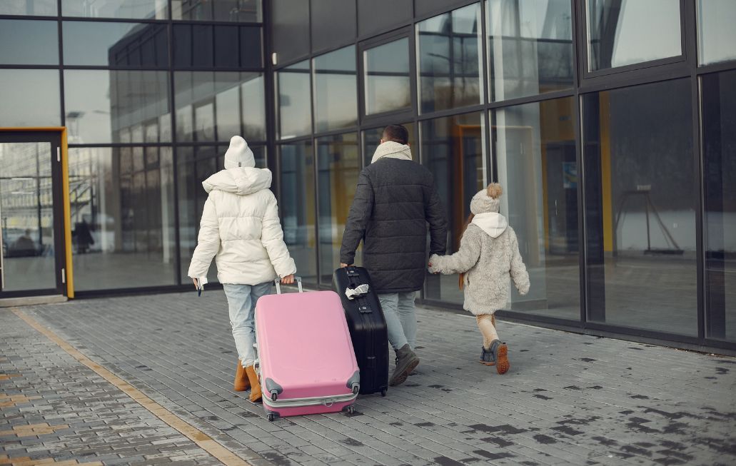 Family heading into the airport in winter