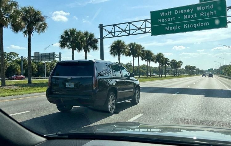 LUXY black car SUV driving to Disney World