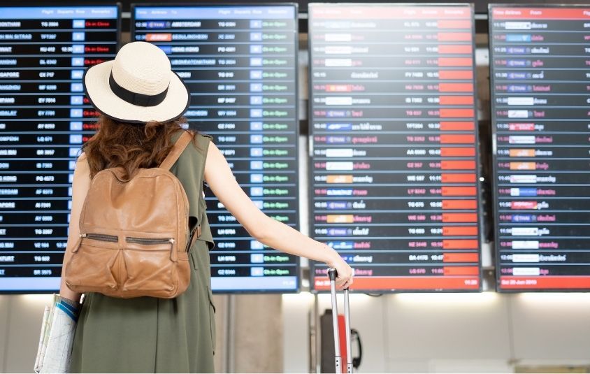 Person looking at the board of flight updates in the airport 