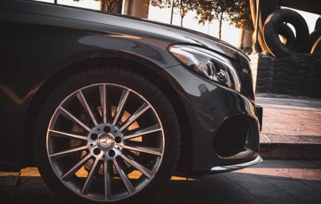 The front of a luxury sedan, parked on the street