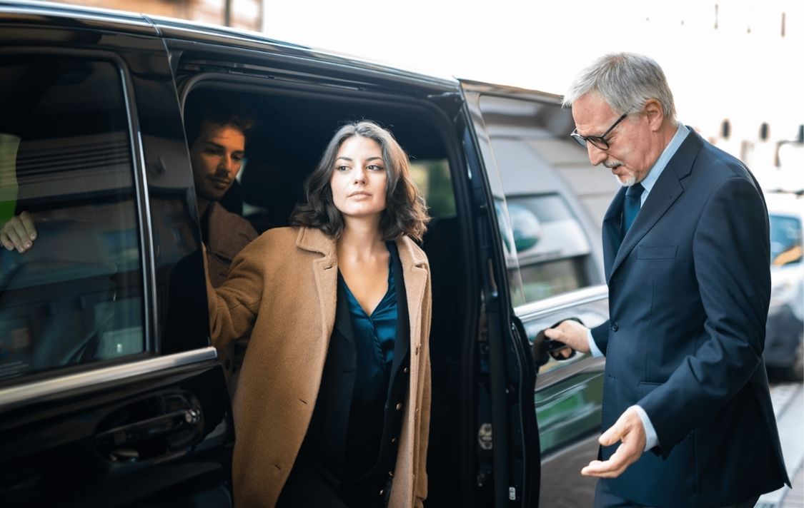 Women stepping out of her black car VIP car service