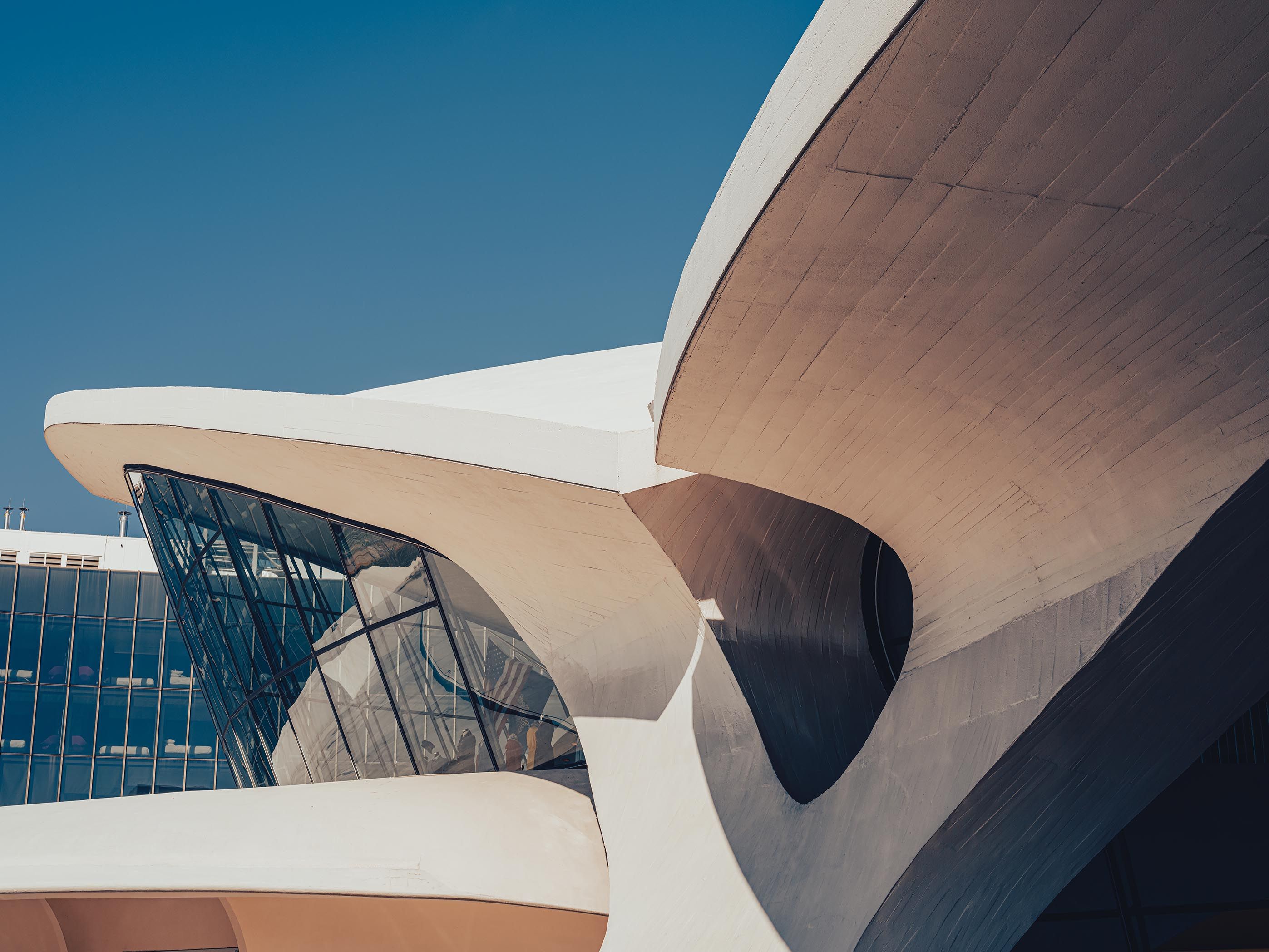 JFK’s TWA Flight Center with sweeping concrete rooflines on a clear day.
